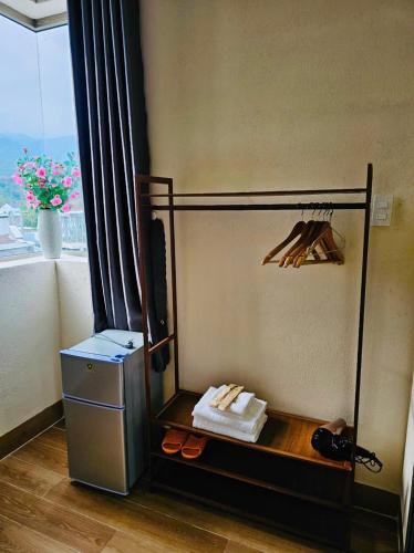 a room with a shelf with shoes and a window at Khách Sạn Trung Loan in Ninh Hải