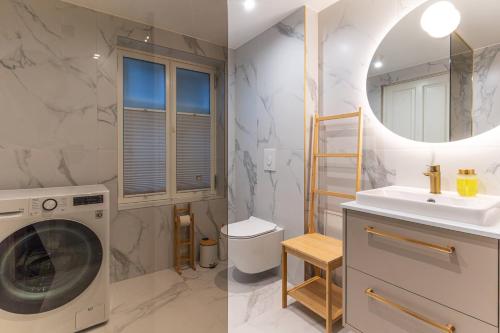 a bathroom with a washing machine and a sink at Fellin Apartment in Viljandi