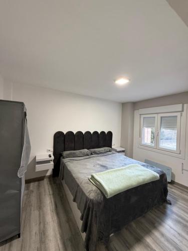 En eller flere senge i et værelse på Alojamiento confort