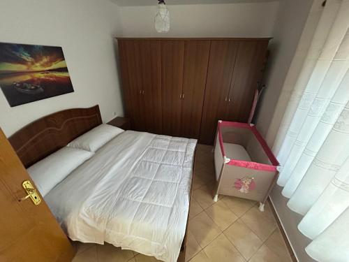 a small bedroom with a bed and a pink bag at Berat FoxHouse in Berat