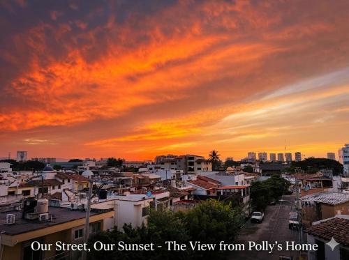 a view of a city with a sunset at Polly's Home Aralias Boutique GuestHouse & PrivateSuites in Puerto Vallarta