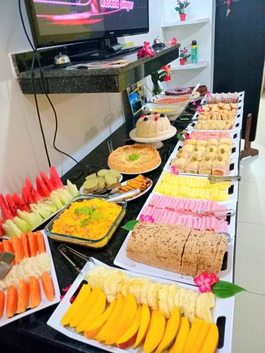a buffet line with many different types of food at Pousada Michele in Morro de São Paulo