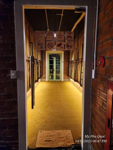 an open door to a hallway in a building at Mi Amor Luxury Hostel located in South Island Center in Phú Quốc
