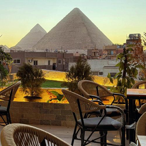 a group of chairs sitting in front of the pyramids at Zahira Pyramids View in Cairo