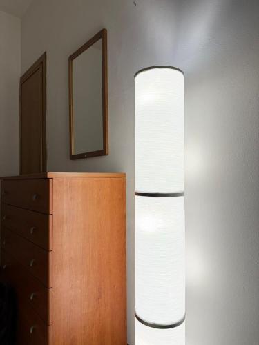 a lamp next to a dresser and a mirror at La Dimora di Siena in Tognazza