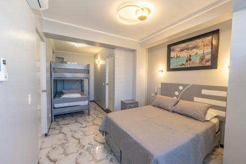 a hotel room with a bed and a bedroom with a bed sqor at Hostal 3 Lunas in Paracas