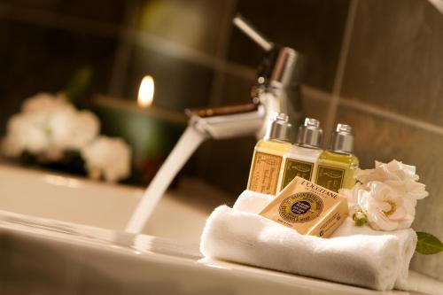 a bathroom sink with two bottles of soap on a towel at Fiori e Frutti Agriresort in Mestre
