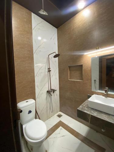 a bathroom with a toilet and a sink at Haider GuestHouse in Karachi