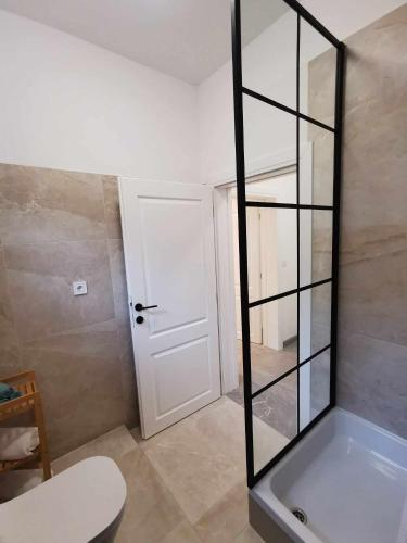 a room with a white door and a glass wall at Apartments and Rooms B&B in Zadar