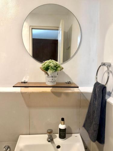 a bathroom with a mirror and a sink at Casa Josa in Antipolo