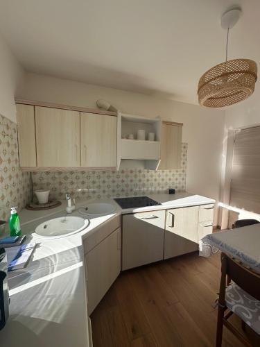 a kitchen with white cabinets and a sink at Cesa Balzan in Canazei