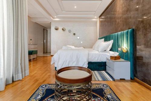 a large bedroom with a bed and a table in it at Large Comfort Duplex Casablanca Center in LʼOasis
