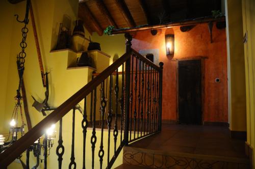 a stairway with a black railing and a door at Condado de San Martín in Boltaña