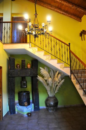 a room with a staircase and a vase with a plant at Condado de San Martín in Boltaña