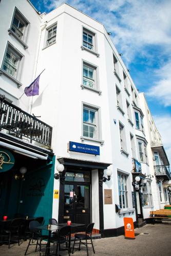 a white building with tables and chairs in front of it at The Royal Oak Hotel in Ramsgate