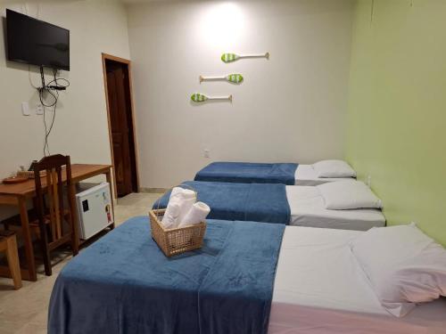 Ein Bett oder Betten in einem Zimmer der Unterkunft Pousada Banzeiro Marajó