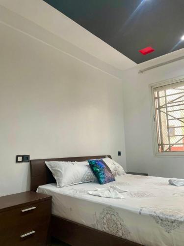 a bedroom with a bed and a window at Le bon coin in Casablanca