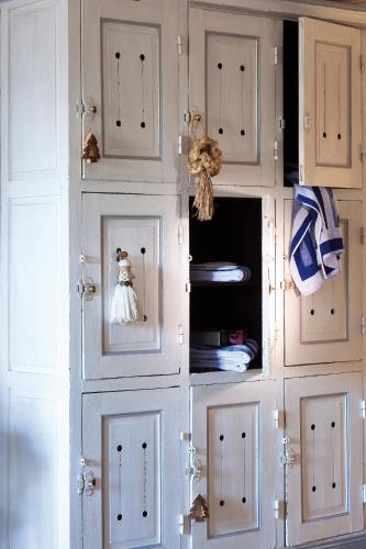 a white cabinet with white doors in a room at Hotel La Sapinière in Brioude