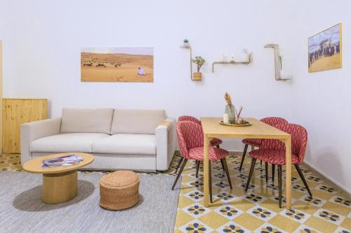 a living room with a couch and a table and chairs at Vintage Rooms in Palermo
