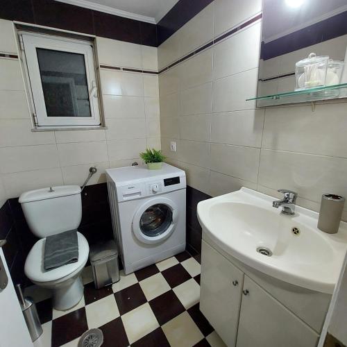 a bathroom with a washing machine and a sink at The Mastiha Spot 5 in Chios