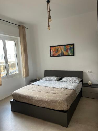 a bedroom with a bed in a white room at Capitan Ale in Sanremo