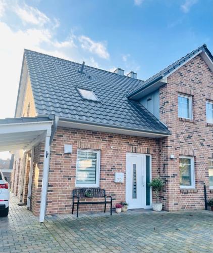 a brick house with a bench in front of it at Emils Heidehaus in Soltau
