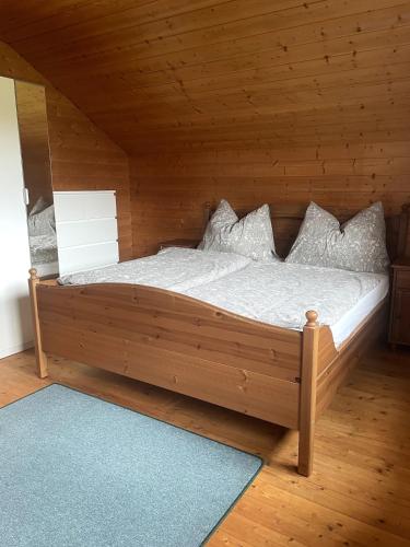 a bedroom with a bed in a wooden room at Charmantes Studio im Seengebiet in Mattsee