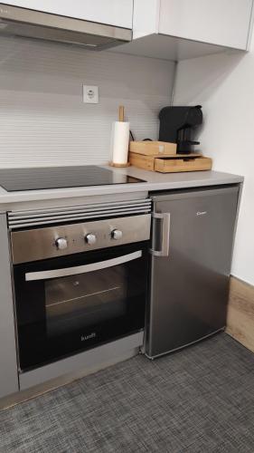 a kitchen with a stove and a dishwasher at Casa da Praça in Murtosa