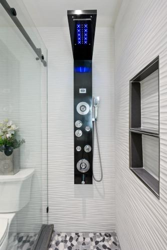 a bathroom with a shower with a control panel at Newport Beach Lux in Newport Beach