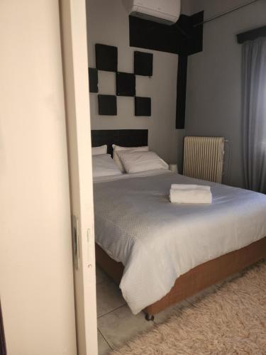 a bedroom with a bed with two towels on it at jim villa in Andravída