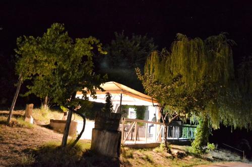 a house at night with trees in the foreground at Condado de San Martín in Boltaña