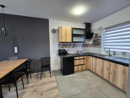 a kitchen with a sink and a table with chairs at Ostoja we Władku in Władysławowo