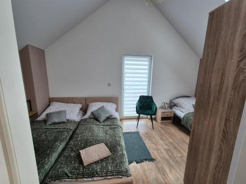 a bedroom with two beds and a window at Ostoja we Władku in Władysławowo