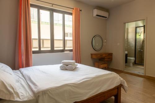 a bedroom with a bed with a teddy bear on it at Paradis des Anges Appartement in Triolet