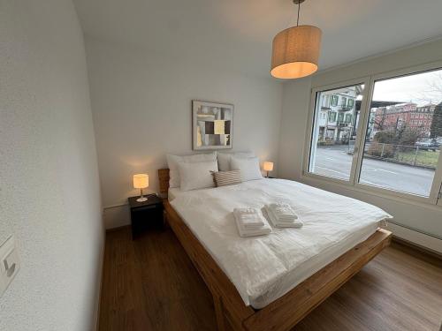 a bedroom with a large bed with a window at Alpine Loft in Interlaken