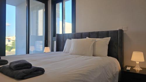 a bedroom with a large bed with a large window at STAY Engomi Gem 2 in İncirli