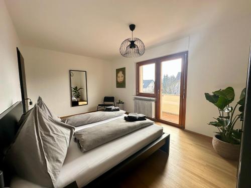 a bedroom with a bed and a potted plant at Apartment 22 in Schlins