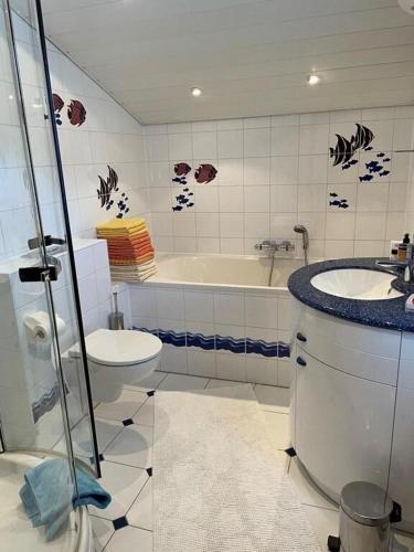 a bathroom with a tub and a toilet and a sink at Holiday home Gröbming Ski Mountains in Gröbming