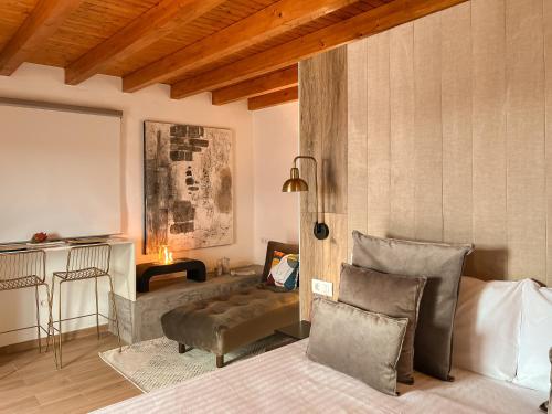a bedroom with a bed and a couch and a table at Canaryislandshost l The Sky Suites in Tinajo