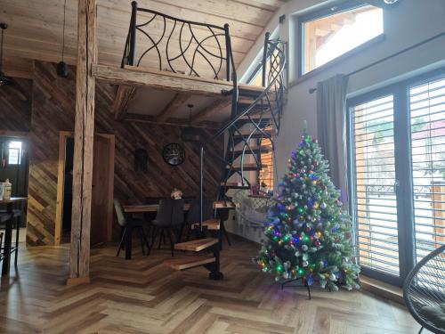 a christmas tree in a room with a staircase at Luxusny apartman z tarasmi - Vera in Telgárt