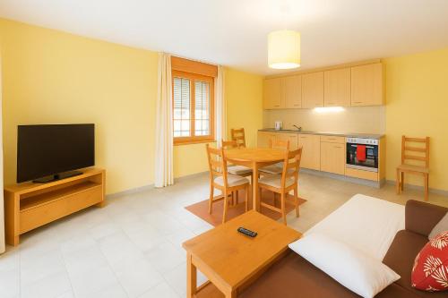 a living room with a couch and a table at WEF Klosters Executive Apartment with Direct Train to Davos in Klosters