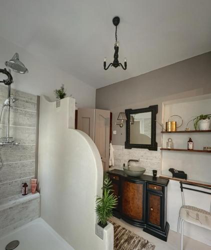 a bathroom with a sink and a mirror at Le Domaine de Cécile by Alto Service in Perpignan