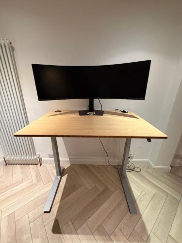 a computer monitor sitting on top of a desk at Victorian Cottage in Central Richmond in Richmond upon Thames
