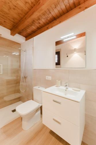 a bathroom with a toilet and a sink and a shower at Canaryislandshost l The Sky Suites in Tinajo