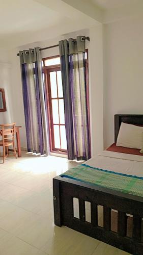 Un dormitorio con una cama y una ventana en Amani Lakeside, en Panadura