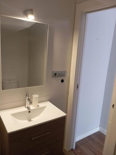 a bathroom with a sink and a mirror at Casa de la Fortuna in Huétor Vega
