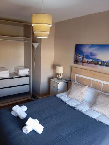 a bedroom with a large bed with towels on it at Casa de la Fortuna in Huétor Vega