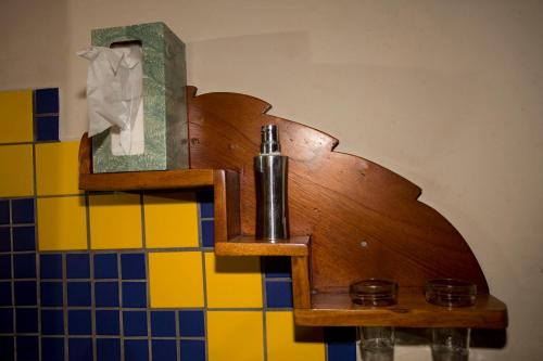 a wooden shelf with a pipe on a wall at Omega Tours Eco-Jungle Lodge in La Ceiba