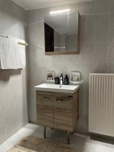 a bathroom with a sink and a mirror at Village House by nature in Karkaloú