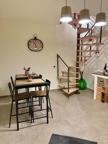 a dining room with a table and a clock on the wall at B&B Arco Trinità in Bari